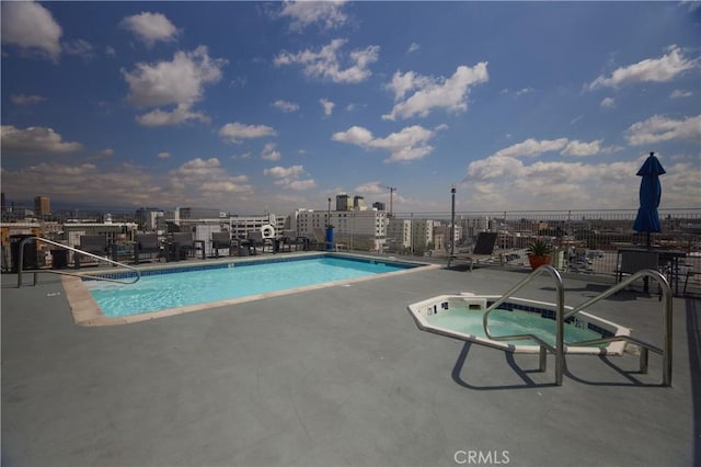 view of swimming pool featuring a patio and a community hot tub