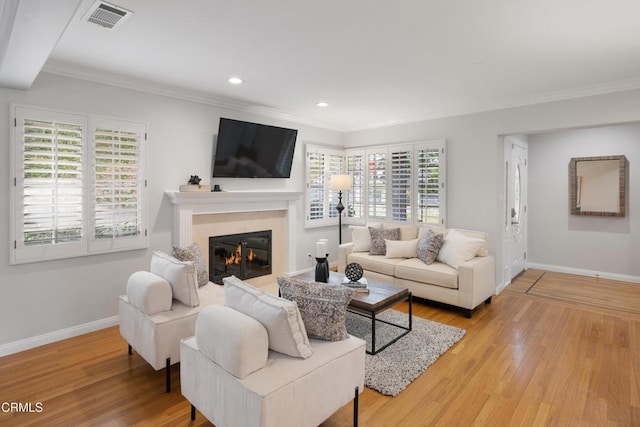 living room with hardwood / wood-style flooring and ornamental molding