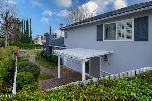 view of property exterior with a pergola