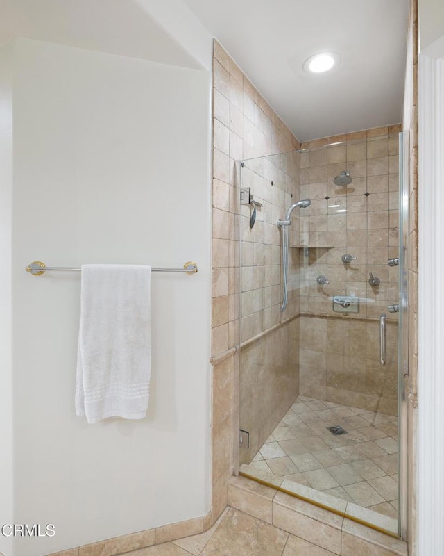 bathroom with tile patterned flooring and a shower with shower door