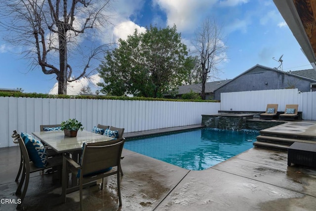 view of swimming pool featuring an in ground hot tub, pool water feature, and a patio