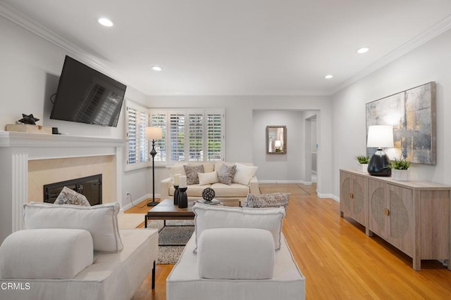 living room with crown molding and light hardwood / wood-style floors