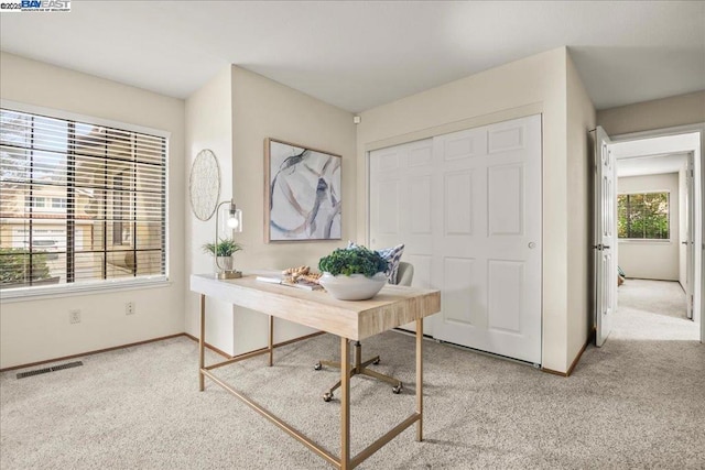 office area featuring light colored carpet