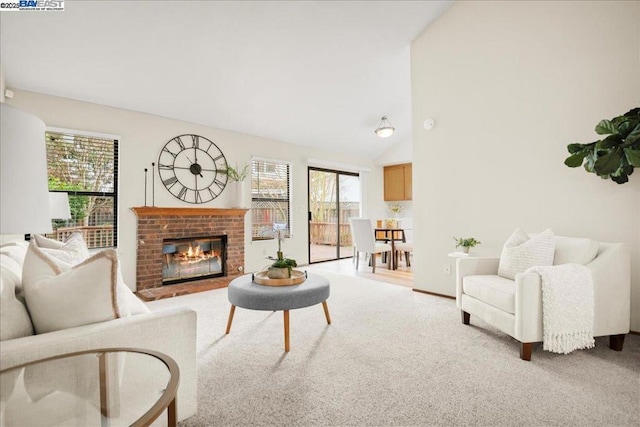 living room featuring carpet, high vaulted ceiling, and a fireplace