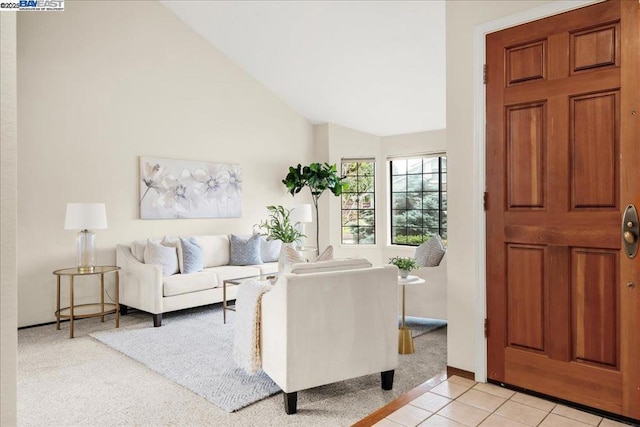 entrance foyer featuring lofted ceiling and light tile patterned floors