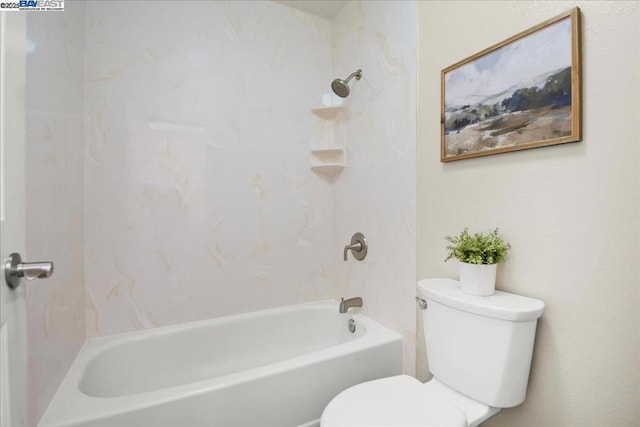 bathroom featuring bathtub / shower combination and toilet