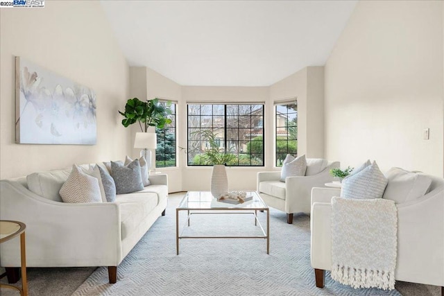 living room with vaulted ceiling and light carpet