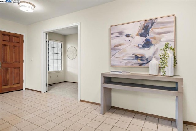 entryway with light tile patterned floors