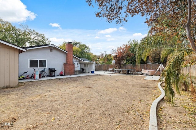 view of yard with a jacuzzi and a patio