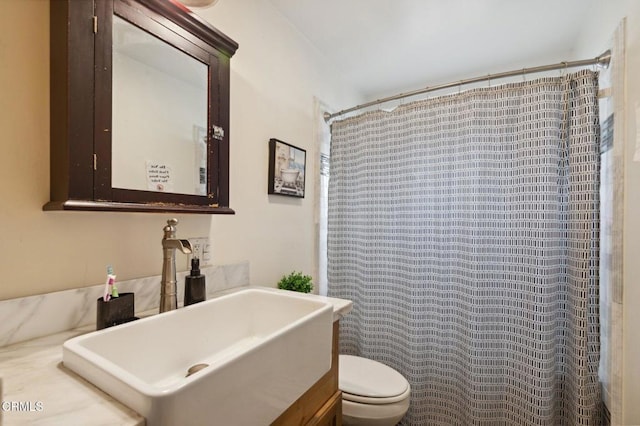 bathroom featuring vanity, a shower with curtain, and toilet