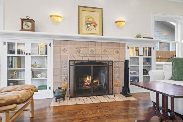 details featuring hardwood / wood-style floors and a tile fireplace