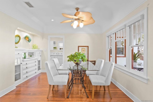 dining area featuring wood-type flooring and ceiling fan