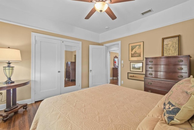 bedroom featuring french doors, ceiling fan, dark hardwood / wood-style flooring, and a closet