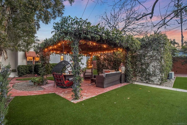 yard at dusk with a patio area and outdoor lounge area