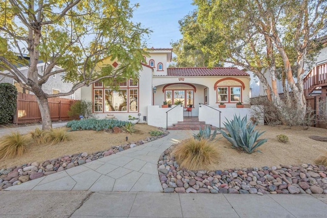 mediterranean / spanish home featuring a porch