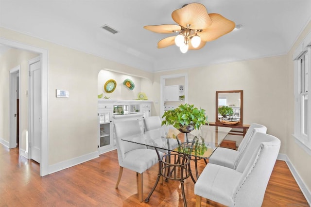 dining room featuring wood-type flooring and ceiling fan