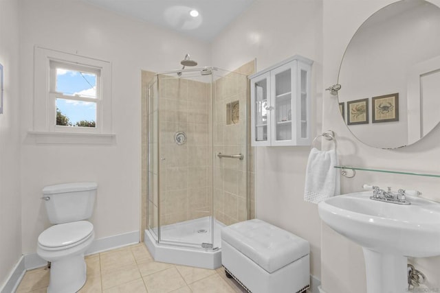 bathroom featuring sink, tile patterned floors, toilet, and a shower with door