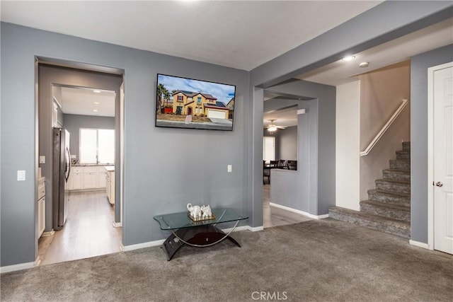 hallway with light colored carpet