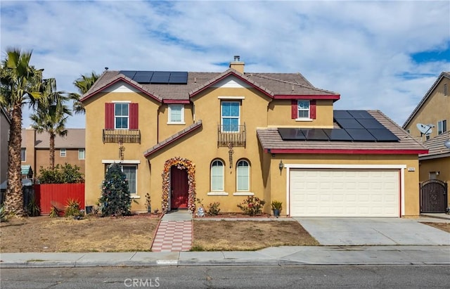 view of front facade with a garage and solar panels