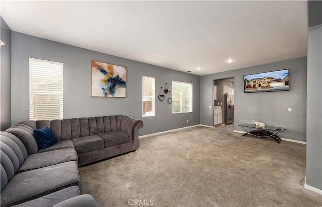 living room with a healthy amount of sunlight and light colored carpet