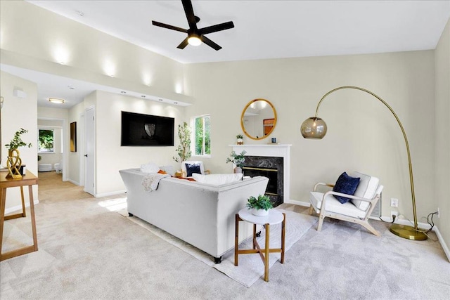 living room featuring vaulted ceiling, light carpet, ceiling fan, and a fireplace