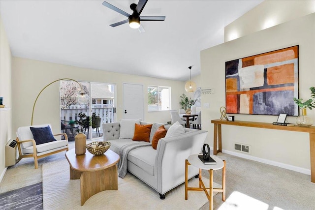 carpeted living room with lofted ceiling and ceiling fan