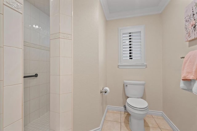 bathroom with tiled shower, tile patterned floors, and toilet