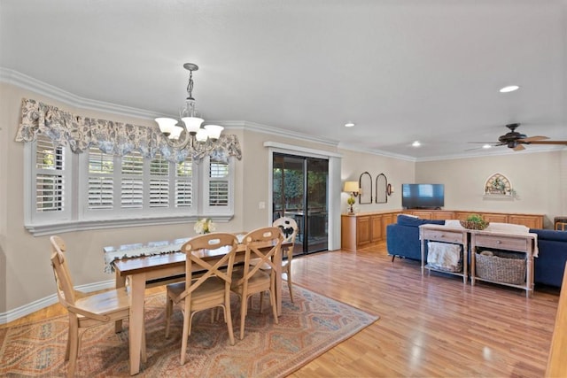 dining room with crown molding, ceiling fan with notable chandelier, and light wood-type flooring