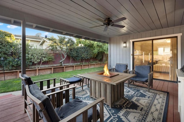 deck with ceiling fan and a fire pit