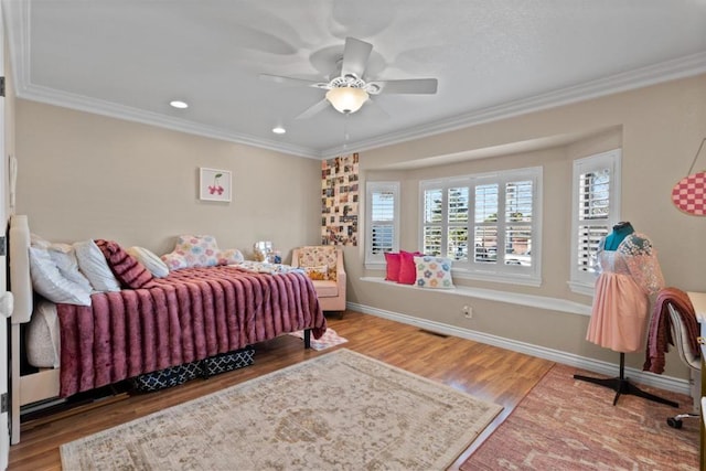 bedroom with crown molding, ceiling fan, and hardwood / wood-style floors