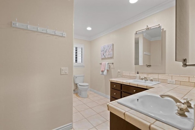 bathroom featuring crown molding, vanity, tile patterned floors, and toilet