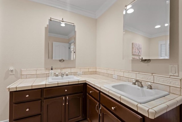 bathroom featuring crown molding and vanity