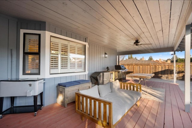 deck with an outdoor living space and ceiling fan