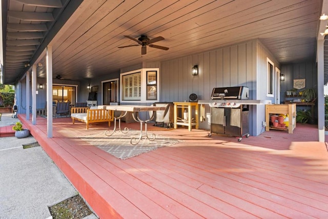 wooden terrace featuring grilling area and ceiling fan