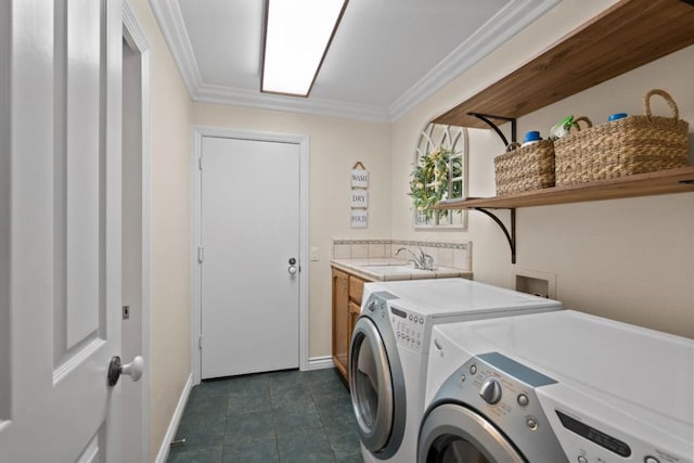 laundry area with sink, dark tile patterned flooring, cabinets, independent washer and dryer, and crown molding