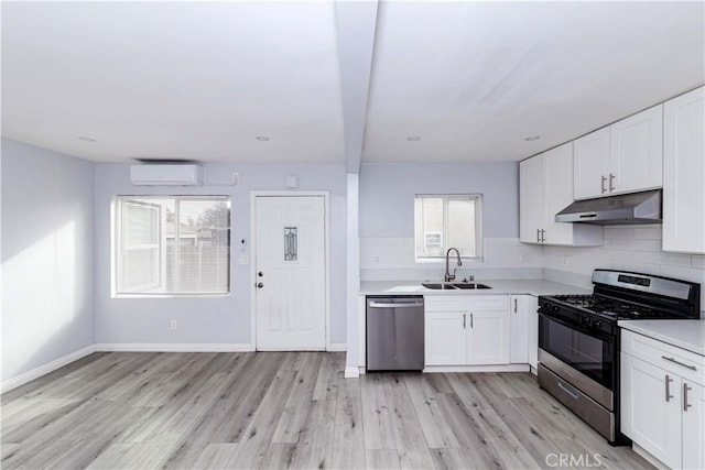 kitchen with white cabinetry, sink, stainless steel appliances, and light wood-type flooring