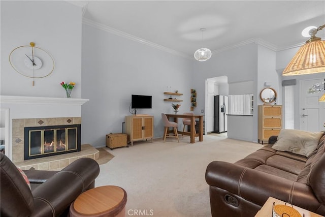 living room featuring crown molding, light colored carpet, and a tile fireplace