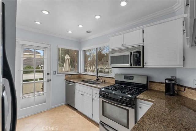 kitchen featuring stainless steel appliances, ornamental molding, sink, and white cabinets