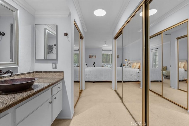 bathroom with ornamental molding and vanity