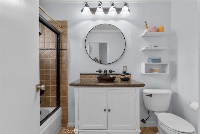 full bathroom featuring tile patterned flooring, enclosed tub / shower combo, vanity, and toilet