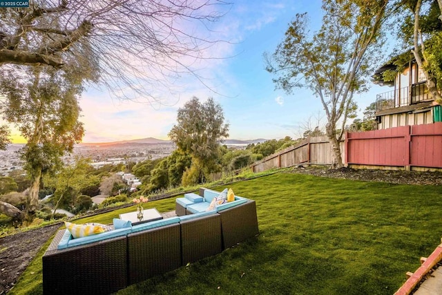 yard at dusk with an outdoor hangout area and a mountain view