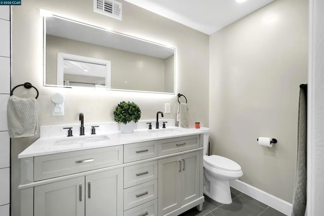 bathroom featuring vanity, tile patterned floors, and toilet