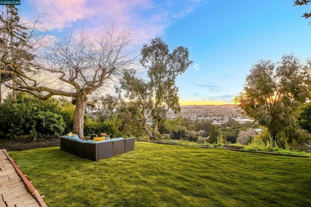 yard at dusk with outdoor lounge area and a mountain view