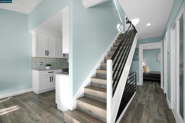 staircase featuring hardwood / wood-style floors