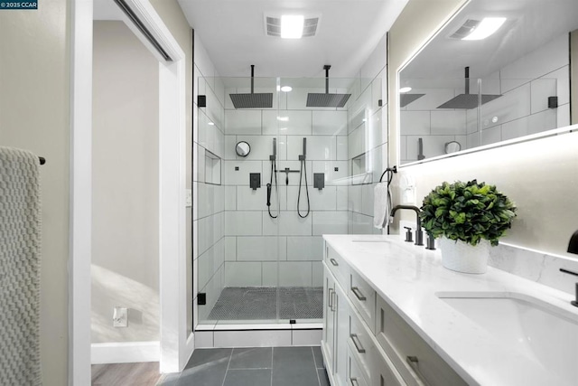 bathroom featuring tile patterned flooring, vanity, and a shower with shower door