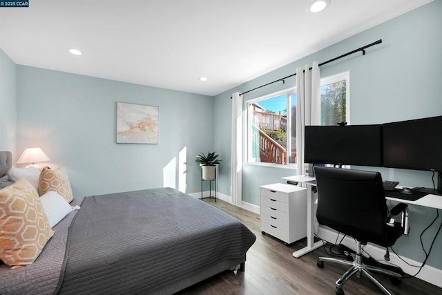 bedroom with dark hardwood / wood-style floors