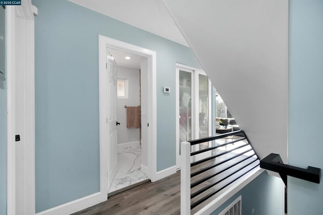 stairway with hardwood / wood-style floors