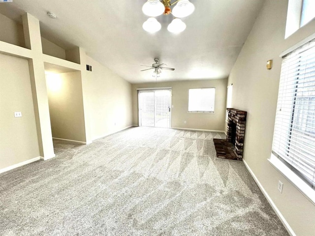 unfurnished living room featuring a fireplace, light colored carpet, ceiling fan, and vaulted ceiling