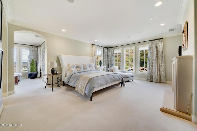 bedroom featuring light colored carpet and ornamental molding