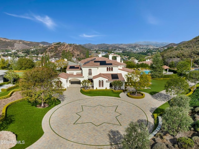 birds eye view of property with a mountain view